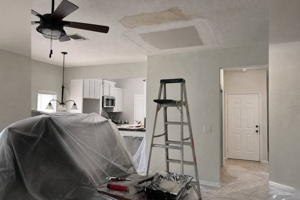 Ceiling drywall repair setup below a water stain for Daytona Beach drywall projects