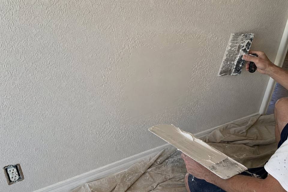 Texture matching and drywall patch repair in progress for Daytona Beach drywall projects